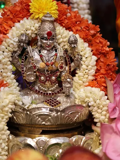 This is a silver Lakshmi idol used in our pooja. I provide guidance on how to perform pooja for different types of idols, whether they are clay, metal, or photos.