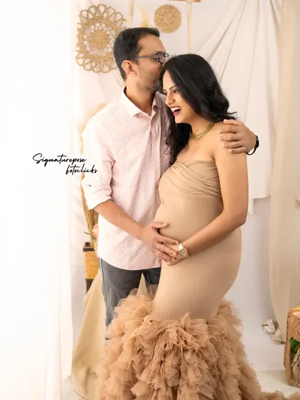 This shot captures the genuine laughter and connection that makes a couple's maternity session so special.