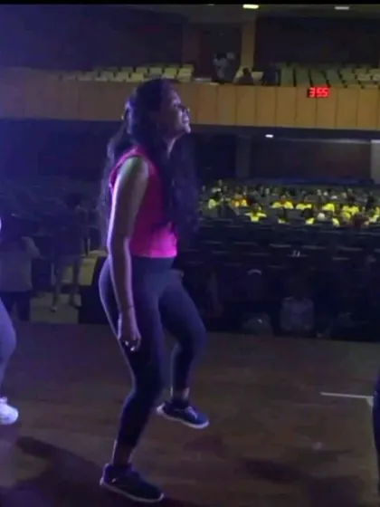 Three of our instructors rehearsing on stage in front of a full auditorium of students. They lead by example, showing the power and passion of performance.