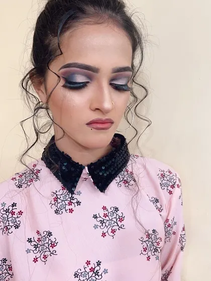 A detailed shot of the smokey eye makeup for the client in the pink shirt.