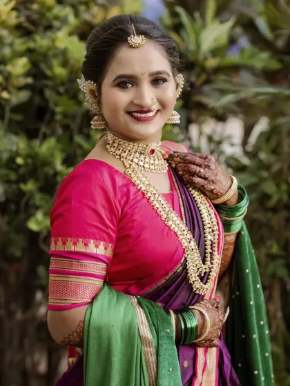 Another lovely portrait of the bride, capturing her gentle smile and the rich colors of her traditional Maharashtrian wedding saree.