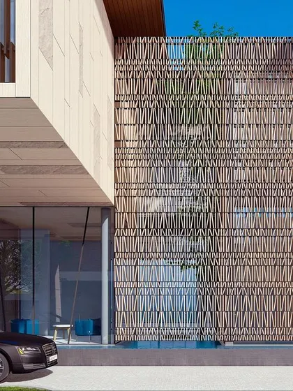 The entryway of a high-end residential design in Goa, featuring a natural limestone jali screen. This intricate screen provides privacy while allowing for ventilation, showcasing our focus on craftsmanship from the very first step.