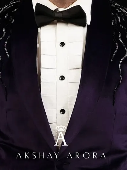 A close-up of the exquisite craftsmanship on our purple velvet tuxedo. The cascading silver beadwork on the shoulders is applied by hand, making each jacket a unique piece of wearable art.