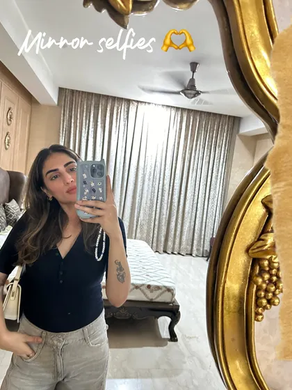 Another mirror selfie from my life haul, showing a casual black top and light pants.