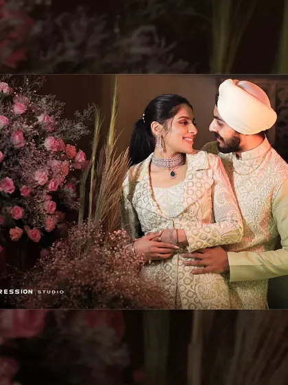 Framed by flowers, this couple shares a look of love and happiness. This portrait from their engagement shoot is full of warmth and romance.