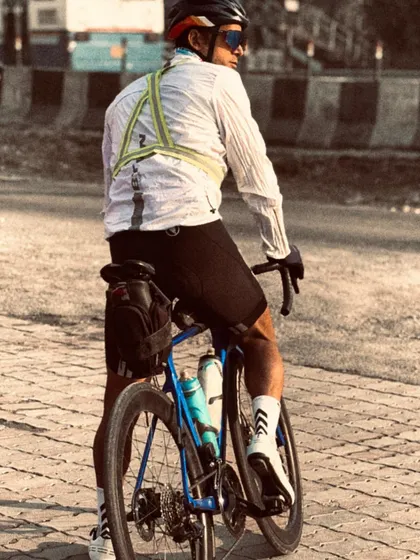 A rider looking back, with the long road ahead. This image captures the solitary yet determined nature of a randonneur.