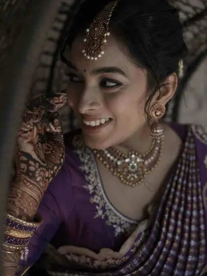 A playful and candid moment from an engagement ceremony. The makeup is subtle and elegant, designed to look beautiful in natural light and capture the bride's joyful spirit.