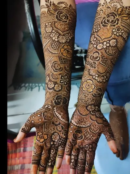 A full bridal design with a beautiful mix of floral and paisley motifs, covering the hands and arms.