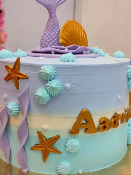 Another angle of the pastel mermaid cake, showing the starfish and wave details that bring the theme to life.
