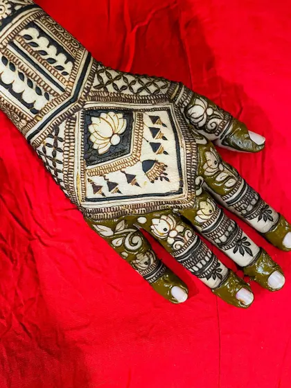 A modern take on bridal mehendi, using bold lines and negative space. The central square features a lotus and jharokha elements, creating a unique, almost architectural feel.