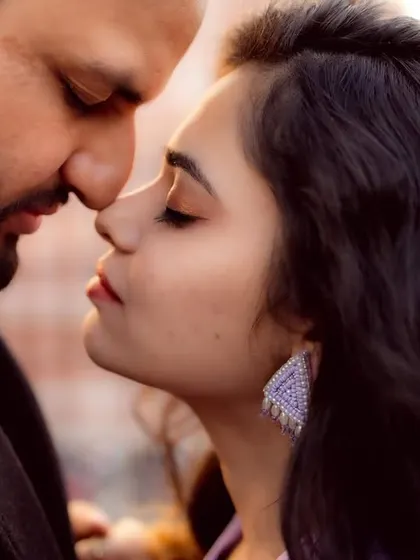 A close-up, intimate moment from a pre-wedding shoot. The soft focus and gentle expressions convey a sense of deep connection and tenderness.