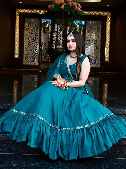 A beautiful teal gown with a ruffled bottom. This is a simple yet elegant rental piece for a guest who wants to look stylish and sophisticated.