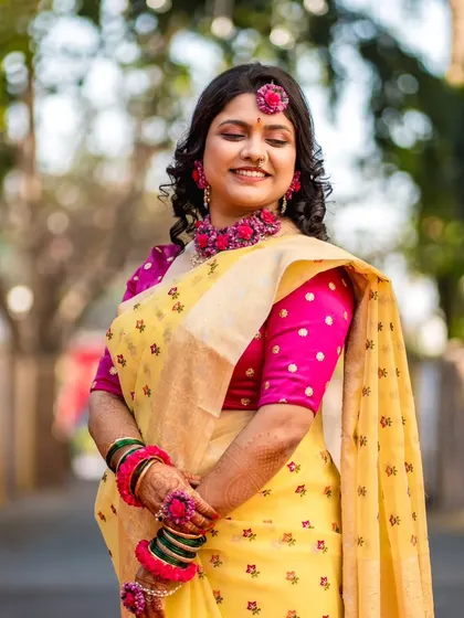 A sweet and shy portrait of the bride during her Haldi ceremony, capturing a moment of quiet joy.