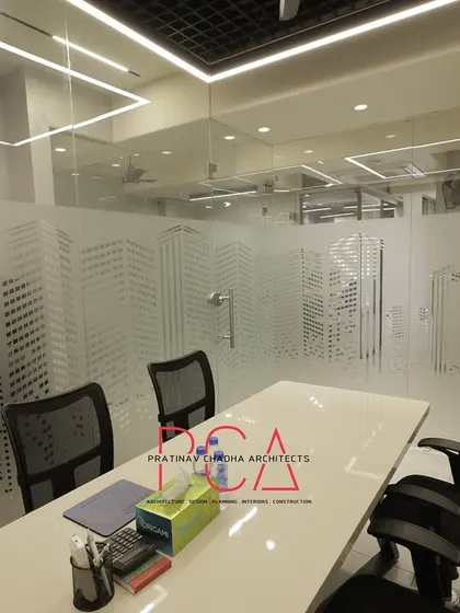 Another view of a meeting space at StyleIn Homes, showing how the frosted glass partitions create a bright and modern feel.