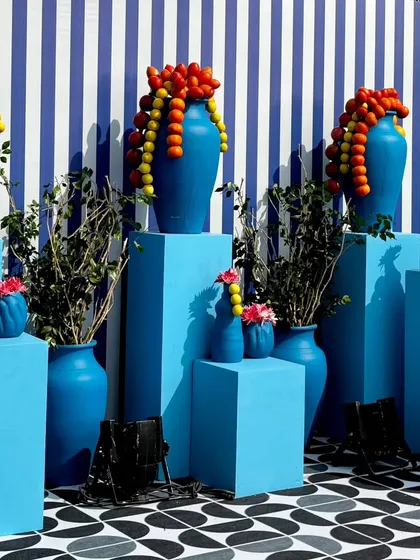 From concept to execution in just 42 hours. This St. Tropez inspired decor in Ahmedabad involved transforming a bungalow with custom-painted walls, fruit-based installations, and unique props, all on a tight deadline.