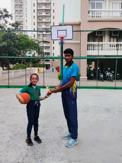 One of our dedicated young players receiving her award from a coach.