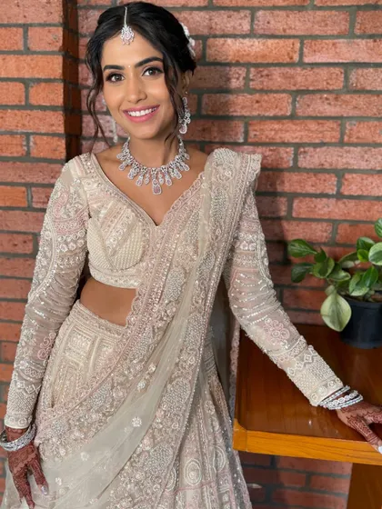 The complete reception look, showing how the soft makeup complements the intricate, shimmering lehenga.