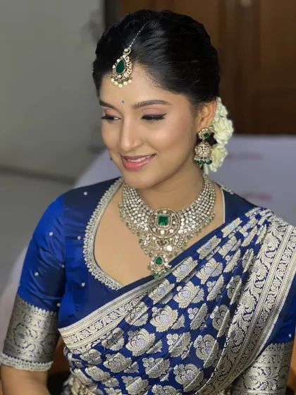 This bride's smile is infectious. The makeup is soft and pretty, with a focus on enhancing her natural features and creating a look of effortless beauty.