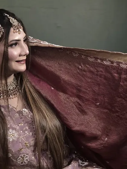 The bride's long, sleek hair provides a beautiful canvas for the traditional jewelry. This look is both modern and timeless.