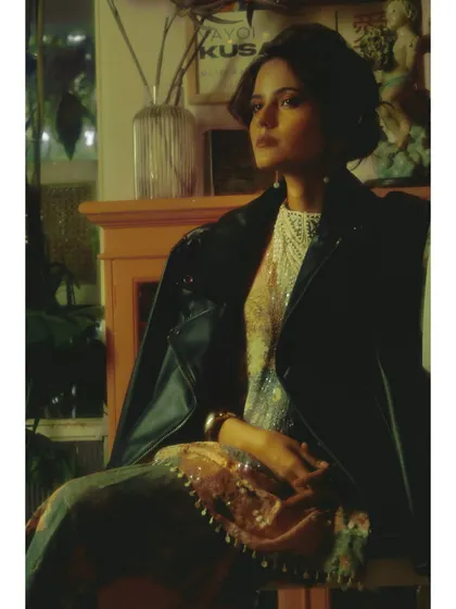 A pensive portrait from the same chapter. The lighting highlights the intricate details of the garment while casting the subject in a thoughtful, somber mood.