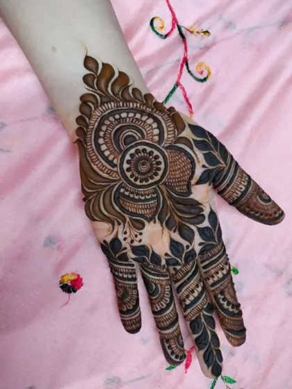 A bold and beautiful design featuring a large, shaded mandala on the back of the hand. This is a statement piece that's perfect for making an impression.
