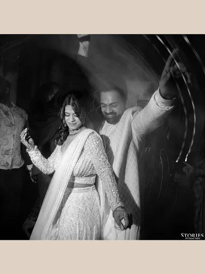 A motion-blur black and white shot of the couple dancing, capturing the energy and movement of the moment.