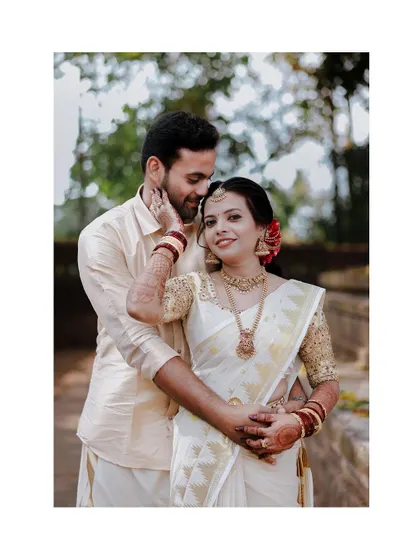 A classic portrait of a couple in their traditional wedding attire, filled with love and happiness.