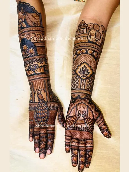 A grand bridal design featuring elephants, swans, and peacocks. The details are sharp and clear, from the lotus flowers on the fingers to the palace dome at the top.