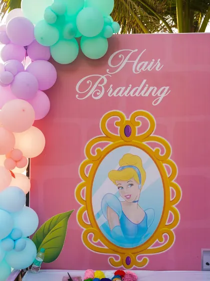 A hair braiding station with a Cinderella theme, offering a fun and glamorous activity for a princess party.