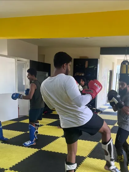 Members practicing their kicks and punches during a group kickboxing class. We build champions by trading blows and pushing each other to be better.