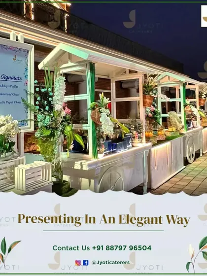 A row of elegant white food carts decorated with fresh flowers, creating a beautiful and unique market-style experience for guests.