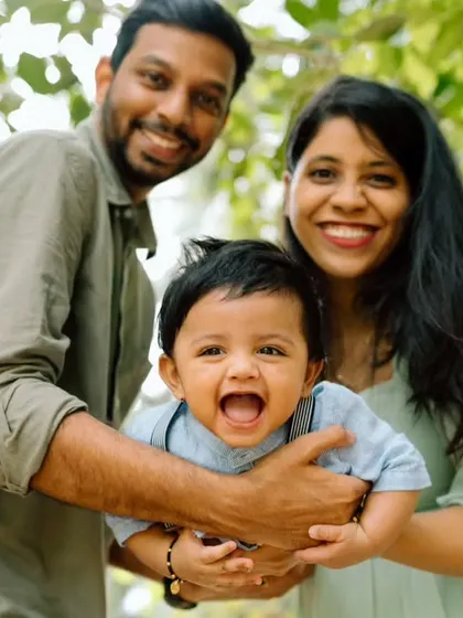 A close-up of the family, their faces full of laughter and love. This candid moment is bursting with happiness.