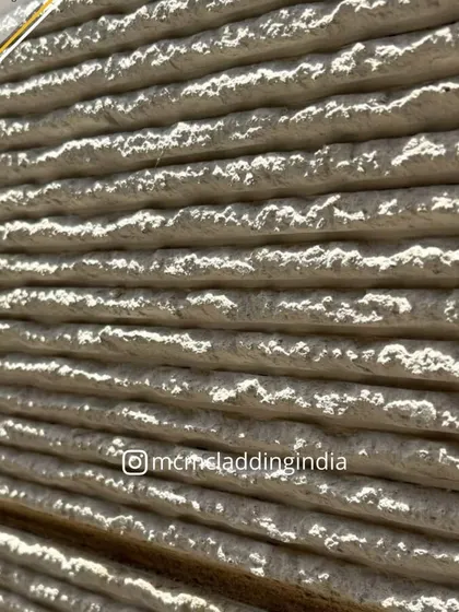 An extreme close-up of the Ittimi clay cladding, highlighting its natural, earthy texture. It's a surface that is as beautiful to touch as it is to see.