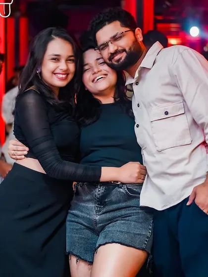 A happy group of friends hugging and smiling, the perfect picture of a great night out.