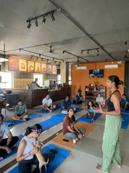 Explaining the purpose of our "Yoga for a Cause" event. These sessions are dedicated to raising awareness and funds for stray animal adoption.