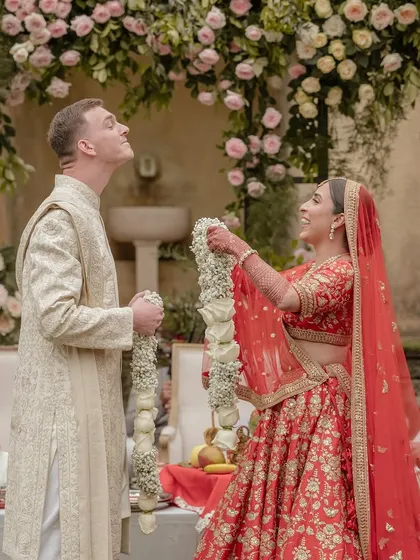 Kingsley instinctively makes it hard for Sheline during the varmala, a playful tradition in Indian weddings. His spontaneous fun and her joyful reaction make for a perfect, unscripted moment.
