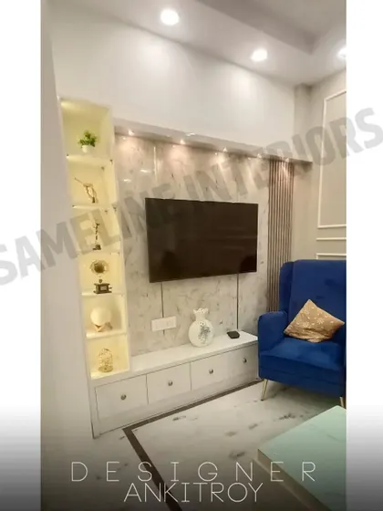 A floating TV unit with a marble-finish back panel and an illuminated display shelf on the side.