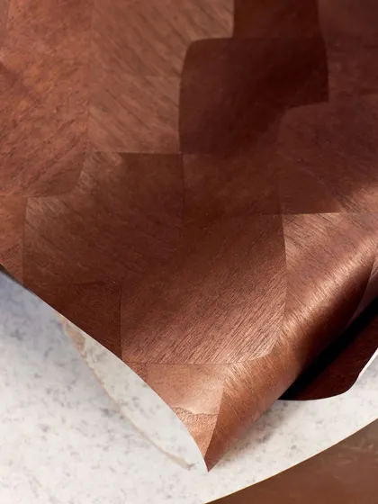 A close-up of a checkerboard wood wallcovering, showing the subtle sheen and texture of the hand-laid paulownia wood slices. The interplay of light and shadow creates an evocative, tactile narrative.