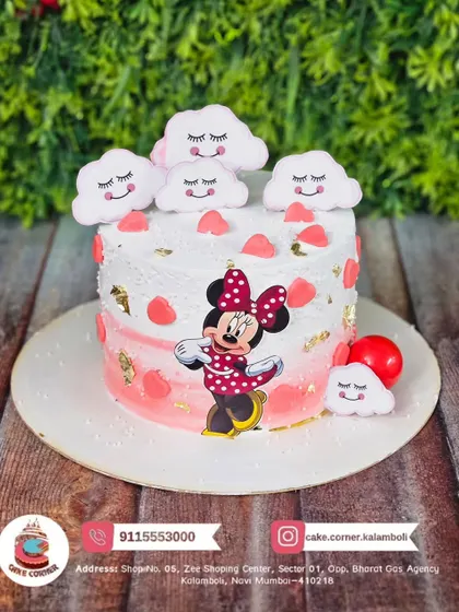 A sweet Minnie Mouse cake with sleepy clouds and hearts. The soft pink and white design is perfect for a dreamy and adorable birthday theme.