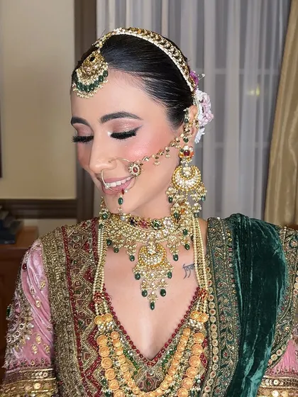 A beautiful smile that lights up the room. The soft pink tones in the makeup give her a fresh and youthful glow.