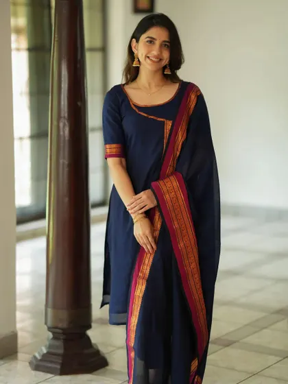 A simple and elegant navy blue kurta set with a traditional woven border on the dupatta. This classic design is a versatile staple for any ethnic wardrobe.