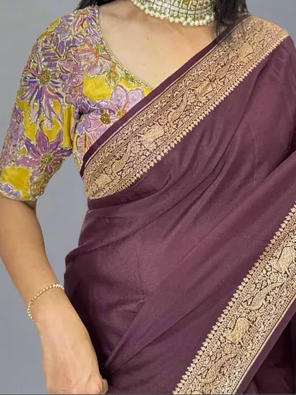 A detailed shot of the border on our dark brown Banarasi saree. The intricate weaving features traditional motifs, showcasing the fine craftsmanship that goes into each piece.