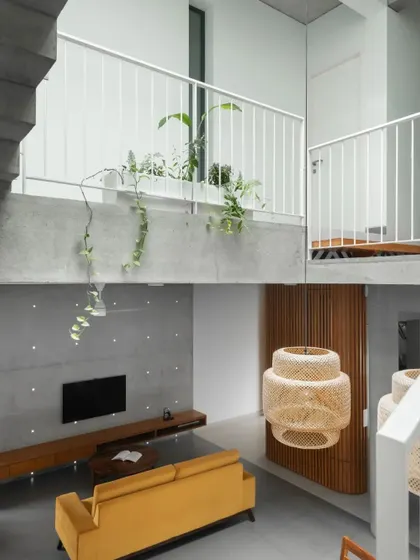 This composite image shows the relationship between the upper-level bridge and the living area below. The design creates visual connections between floors, fostering a sense of a single, interconnected family home.