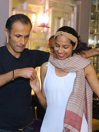 A man gently leads his partner, who is smiling and enjoying the dance. It highlights the respectful and fun environment we foster.
