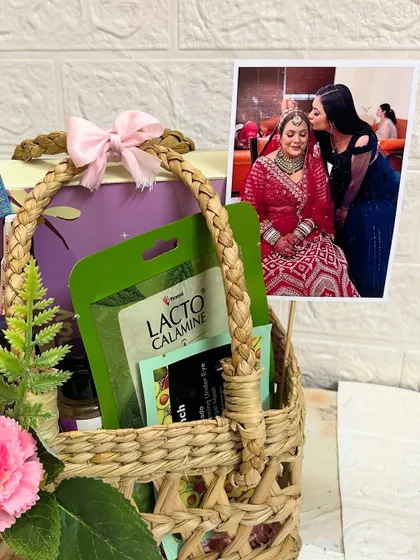 A close-up of the sister's Rakhi hamper, showing the Lacto Calamine face mask and other self-care goodies.