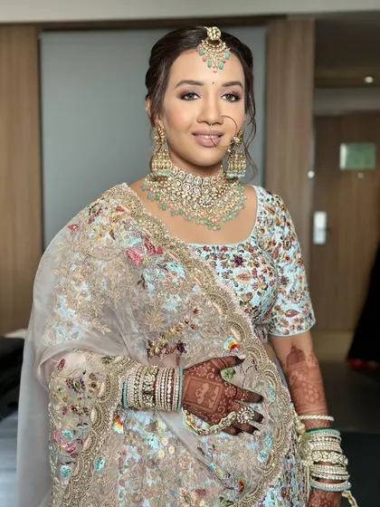 A three-quarter shot showing how the entire look comes together with the intricate lehenga and henna.