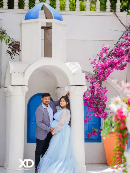 A beautiful couple's portrait at a Santorini-inspired set, complete with blooming bougainvillea.