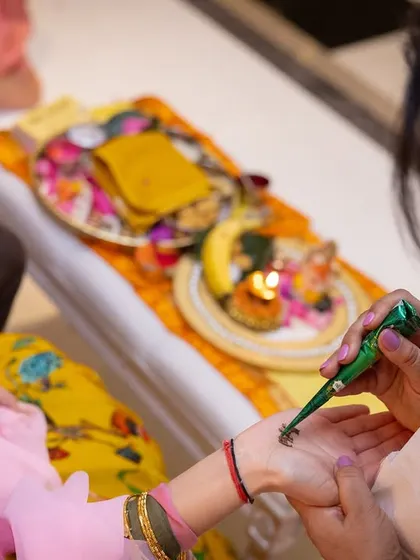 A close-up of the mehndi ritual during a Kurmai ceremony. These intimate family gatherings are where our food helps create a warm and celebratory atmosphere.