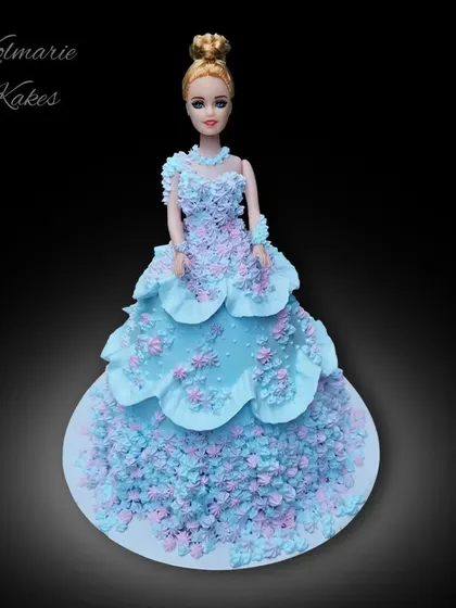 My first Barbie doll cake! The doll is dressed in an elaborate gown made entirely of cake and decorated with hundreds of tiny blue and pink buttercream flowers.
