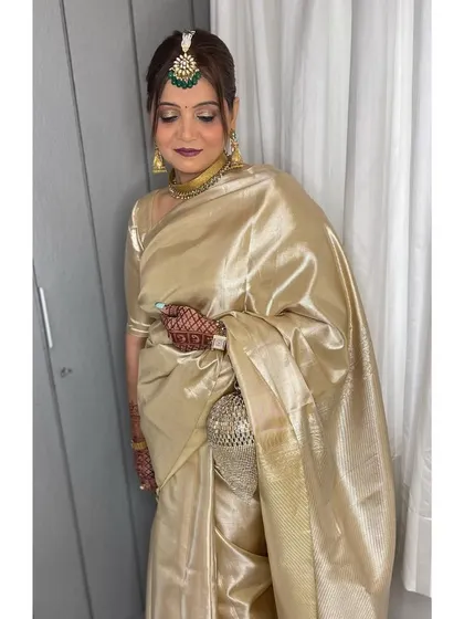 It's an honor to get the mother of the bride ready. For her, I created a timeless and elegant look with a classic hair bun and makeup that enhanced her natural grace, perfectly complementing her beautiful golden saree.